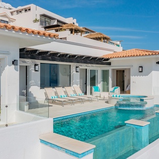Poolside view of the patio and exterior of villa