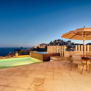 Sunset paints the sky as the rooftop terrace awaits. Soak in the heated pool, dine under the stars, and watch coastal hillside lights twinkle to life.