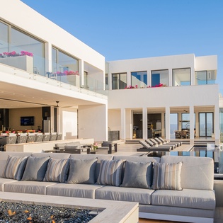 Poolside with incredible ocean and city views at night