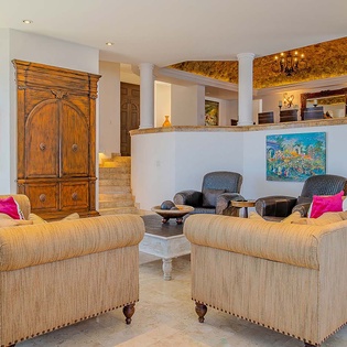 Sink into plush sofas in your elegantly appointed living space, where warm textures and artistic touches invite you to unwind after a day of exploring.