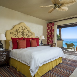 Wake up to endless ocean views from your luxurious bedroom, where vibrant colors and elegant furnishings create your perfect seaside retreat.
