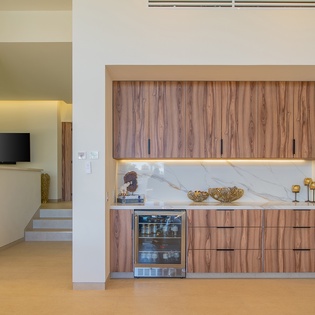 Your sleek kitchen features marble countertops, warm wood cabinets, and modern appliances for cooking comfort.