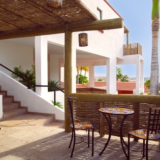 Sip your morning coffee at your private terrace table, surrounded by tropical palms and modern Mexican architecture.