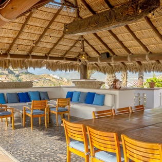 Outdoor seating and dining under the palapa