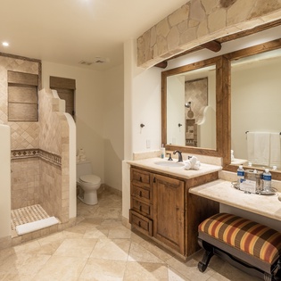 En suite bathroom with walk in shower and double sink