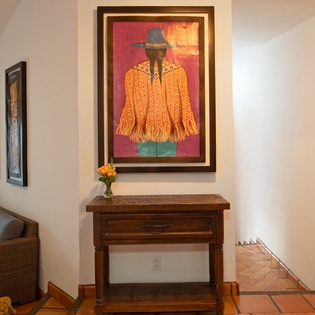Step into your artistic retreat where vibrant Mexican folk art and warm terracotta tiles create an authentic, welcoming atmosphere for your cultural escape.