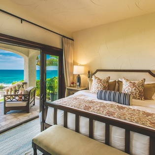 Bedroom suite with patio access and  ocean views