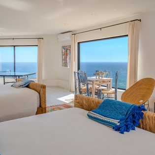 Wake up to endless ocean views from your comfortable beds, then enjoy meals at your private dining table while watching waves sparkle beyond floor-to-ceiling windows.