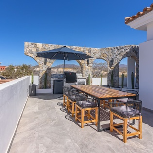 Outdoor dining area with BBQ grill and views