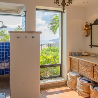 En suite bathroom with walk in shower and ocean views