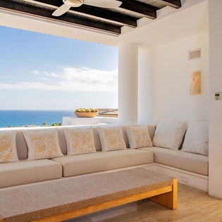 Sink into plush cushions on your private terrace and let the endless blue horizon wash over you. With the sea stretching to the edge of the sky, this is your serene escape.