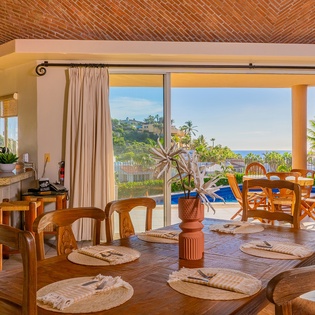 Dining area with patio access and ocean views