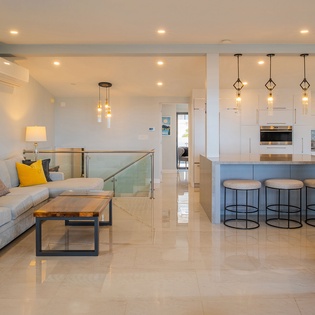 Relax in your stylish open-plan retreat with modern kitchen, cozy seating, and contemporary design perfect for memorable stays.