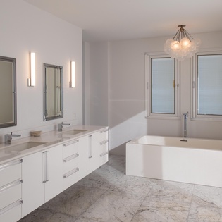 Unwind in your luxurious master bathroom with dual vanities, elegant marble surfaces, and a stunning soaking tub bathed in natural light.