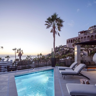 Poolside deck with lounge chairs and ocean views