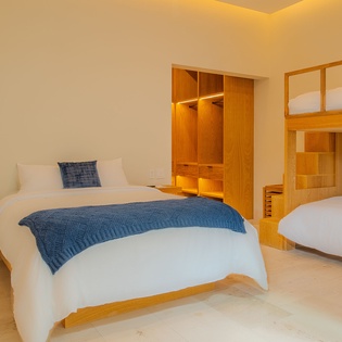 Rest peacefully in your stylish bedroom with crisp linens, warm wood accents, and thoughtful storage for all your belongings.