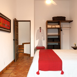 Relax in this charming bedroom with crisp linens, rustic touches, and thoughtful amenities including your own plush robe awaiting.