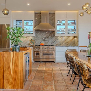 Your dream culinary escape awaits in this stunning gourmet kitchen, where gleaming appliances, warm wood tones, and elegant lighting create the perfect space for memorable meals and gatherings.