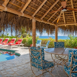 Patio with outdoor seating under palapa