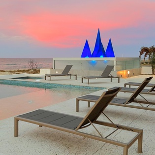 Lounge poolside with beachfront views