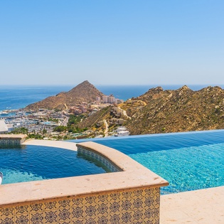 Dive into your private infinity pool while soaking up breathtaking ocean and mountain views that stretch endlessly before you.