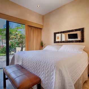 Wake up to lush garden views from your luxurious king bed. Enjoy the serene ambiance of this thoughtfully designed space, where comfort meets tropical elegance.