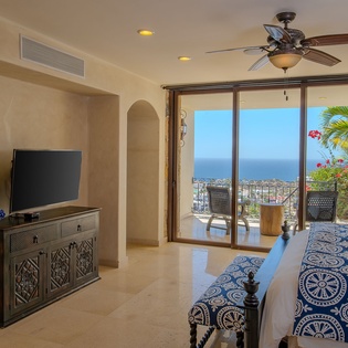 Relax in your elegant bedroom with stunning ocean views. Step onto your private balcony and soak in tropical paradise beyond sliding doors.