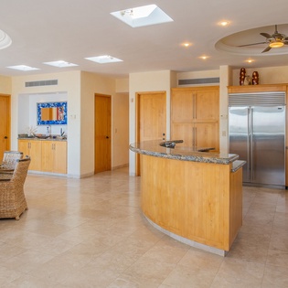 Cook in your spacious open kitchen with granite counters, stainless steel appliances, and tropical breezes from the ceiling fan overhead.