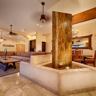 Step into your spacious retreat where a striking natural wood feature anchors the open-concept living space, blending rustic charm with modern comfort for your perfect getaway.