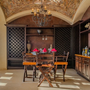 Your private wine cellar awaits with handcrafted storage, elegant seating, and a stunning mosaic ceiling for intimate tastings.