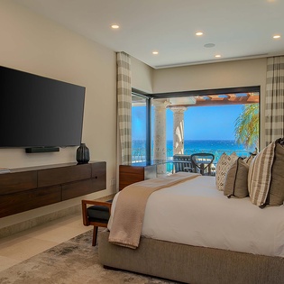Wake up to stunning turquoise waters just beyond your private balcony. This serene bedroom blends modern comfort with breathtaking ocean views, perfect for your tropical escape.