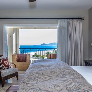 Bedroom suite with balcony and ocean views