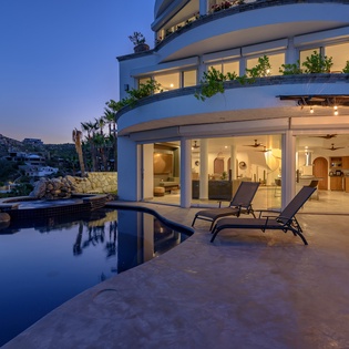 Poolside with ocean views during night time