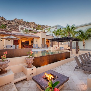Stunning villa perched against dramatic desert hillside offers a luxurious outdoor haven. Unwind by your private pool, gather around the fire pit, and soak in breathtaking mountain views under open skies.