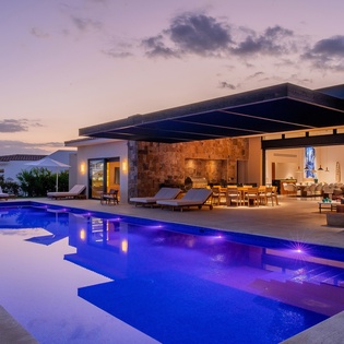 Poolside view of exterior during sunset