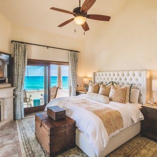 Bedroom suite with patio access and ocean views