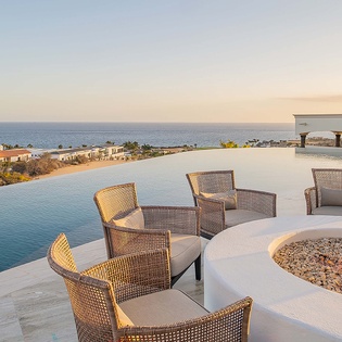 Unwind by the infinity pool with stunning ocean views stretching to the horizon, as the fire pit crackles nearby and the golden hour light warms your perfect getaway.