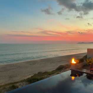 Pool with ocean view during sunset