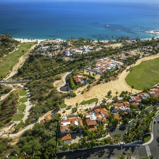 Stunning coastal resort community with pristine beaches, championship golf course, and luxury villas nestled between ocean and manicured greens.