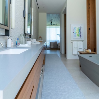 En suite bathroom with double sink and bath tub