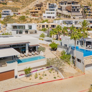 Stunning hillside development featuring modern villas with private pools nestled in tropical landscaping.