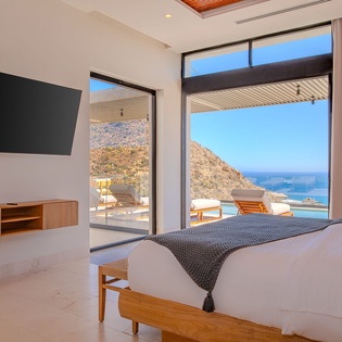 Wake up to breathtaking sea views from your luxurious bedroom, where floor-to-ceiling windows frame the sparkling coastline perfectly.