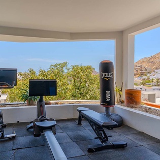 Work out with stunning mountain and village views framing your fitness routine. This private gym space keeps you motivated with natural light and coastal scenery.