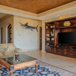 Relax in your spacious living room with soaring brick ceiling, built-in entertainment center, and comfortable seating perfect for unwinding.