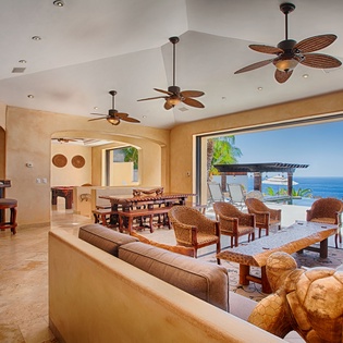Step into your expansive living space where tropical breezes meet stunning ocean views. Relax on plush seating, gather at the dining table, or unwind at your private bar—all framed by paradise.