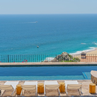 Stunning oceanfront infinity pool overlooking pristine turquoise waters, where you can soak up endless ocean views while lounging poolside in paradise.