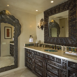 Step into your luxurious bathroom featuring hand-carved vanities, colorful tile accents, and elegant mirrors that create a spa-like retreat.