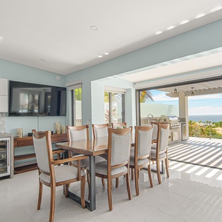 Dining area with patio terrace access and ocean views