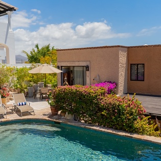 Stone patio with sun deck and pool