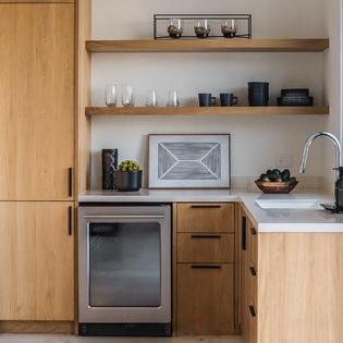 Your modern kitchen features warm wood cabinets, sleek countertops, and thoughtful open shelving stocked with essentials for memorable home-cooked meals.